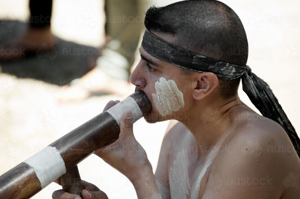 Young Aboriginal Man Playing Didgeridoo - Australian Stock Image