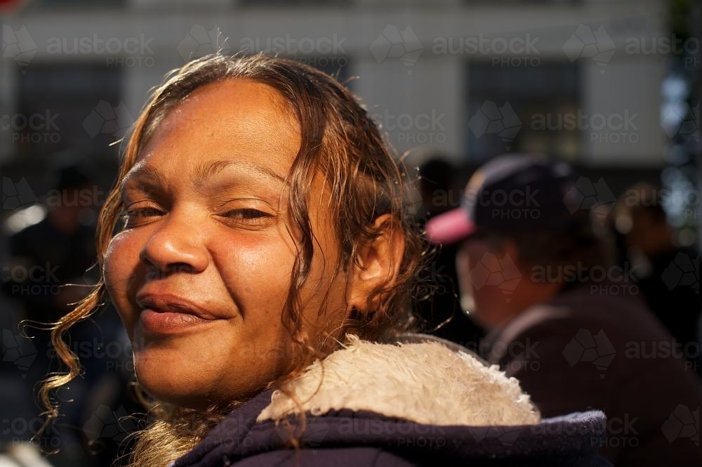 Young Aboriginal Woman Looking Back over her Shoulder - Australian Stock Image