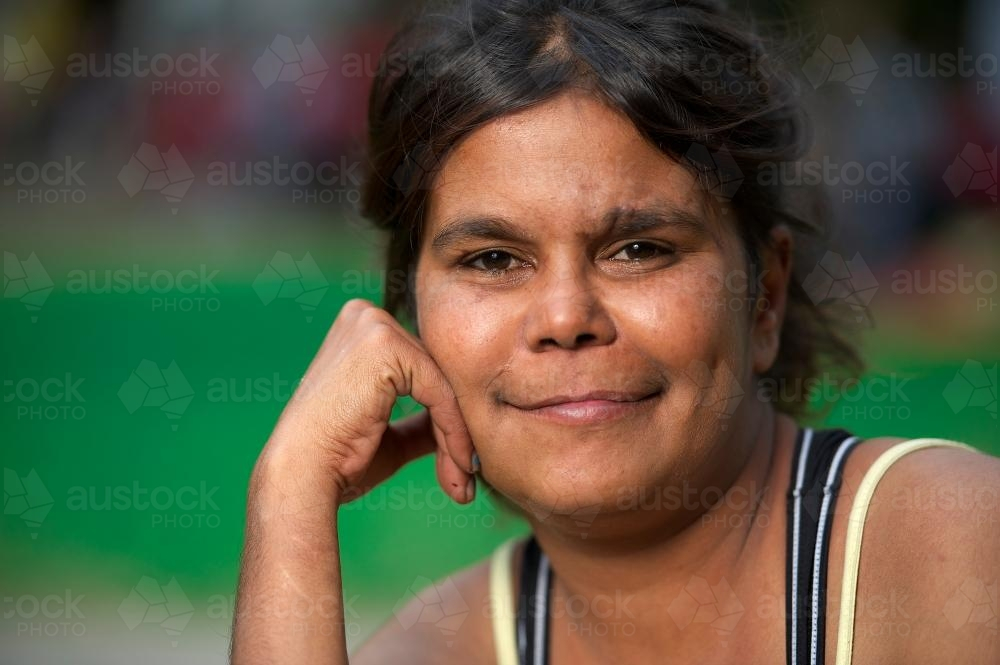 Young Aboriginal Woman resting her head on her right hand - Australian Stock Image