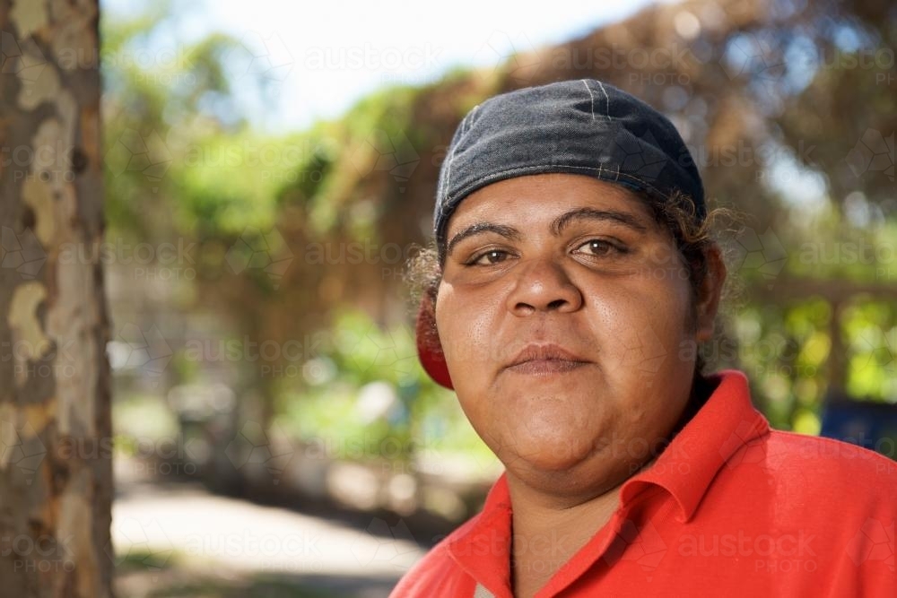 Young Aboriginal Woman with a Red Polo shirt - Australian Stock Image