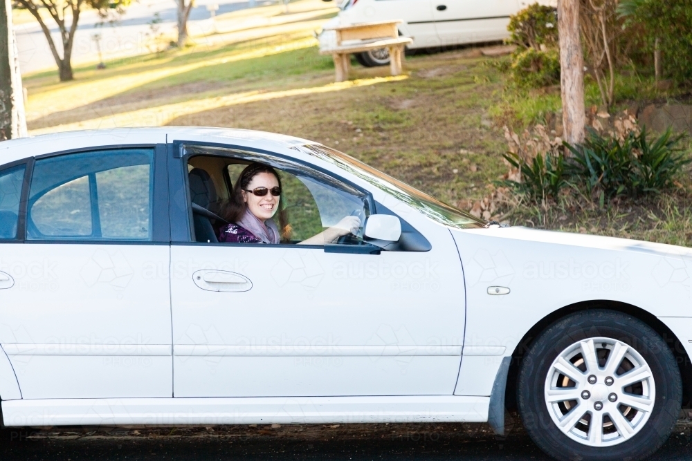 Young adult driver in car on side of road - Australian Stock Image