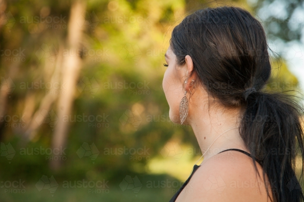 Young adult looking into distance with green copy space - Australian Stock Image