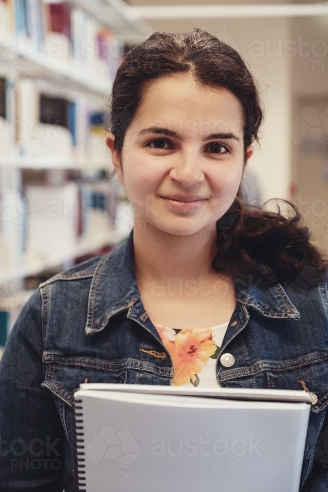 Young adult student in university library - Australian Stock Image