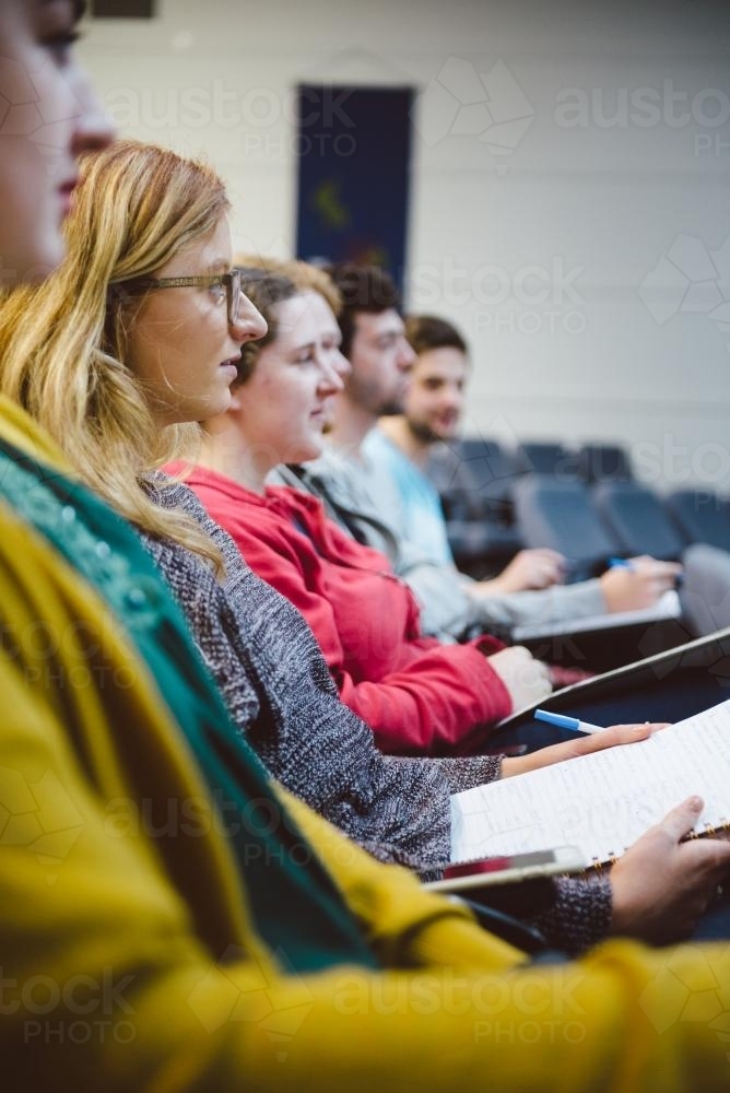 Young adult students sitting in a university lecture hall - Australian Stock Image