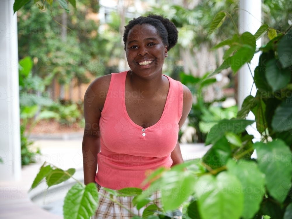 Young African woman in university courtyard - Australian Stock Image