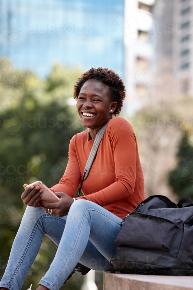 Young African woman photographer laughing - Australian Stock Image