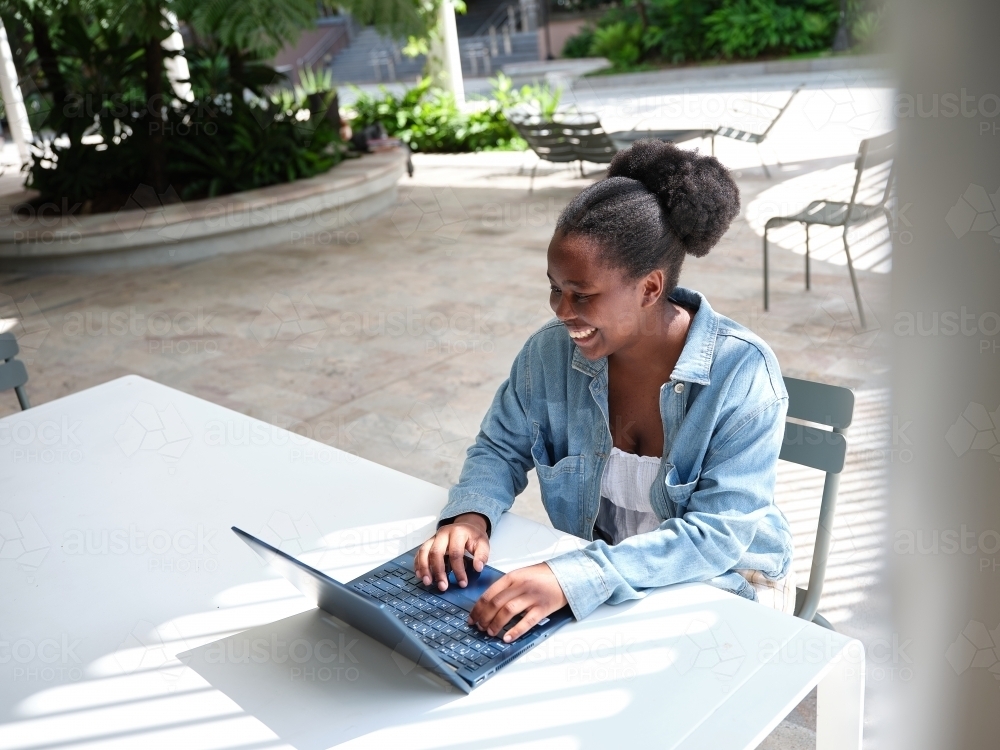 Image of Young African woman using a computer on university campus ...
