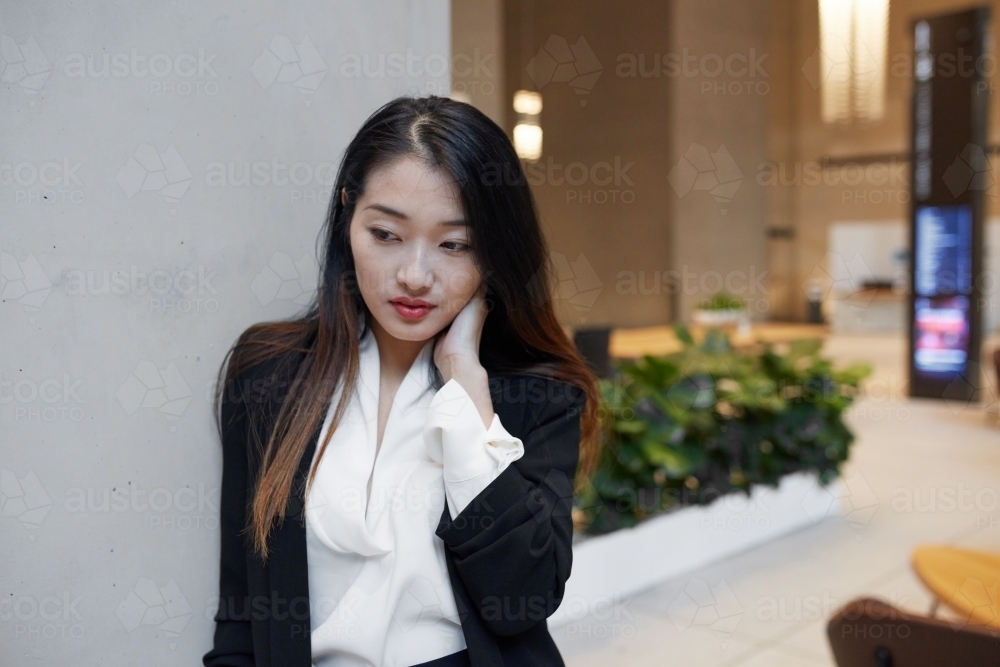 Young anxious Asian businesswoman - Australian Stock Image