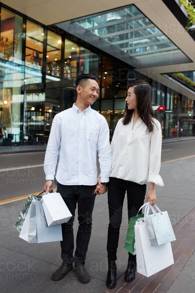 Young Asian couple shopping together in city - Australian Stock Image