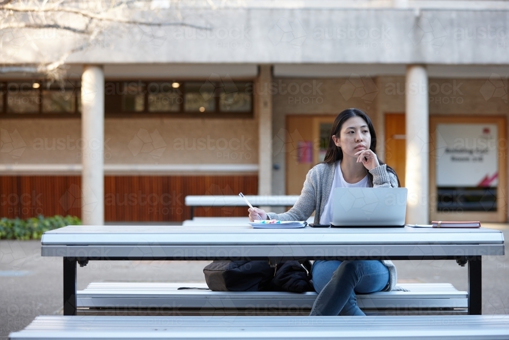 Image of Young Asian female university student studying on laptop ...