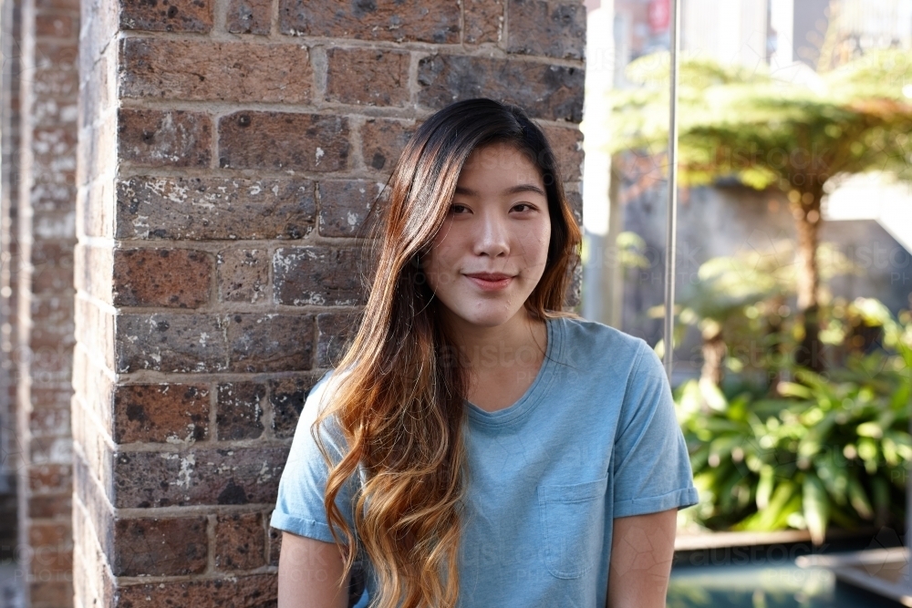 Young Asian woman enjoying time outdoors at enclave - Australian Stock Image