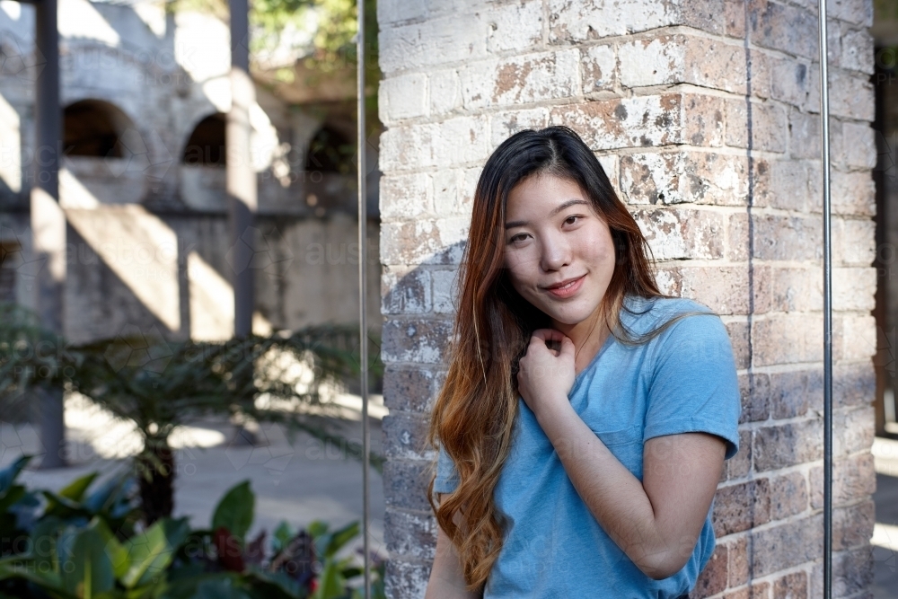 Young Asian woman enjoying time outdoors at enclave - Australian Stock Image