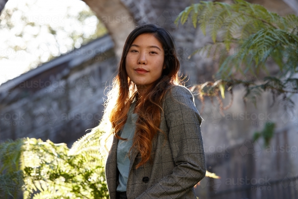 Young Asian woman enjoying time outdoors at enclave - Australian Stock Image