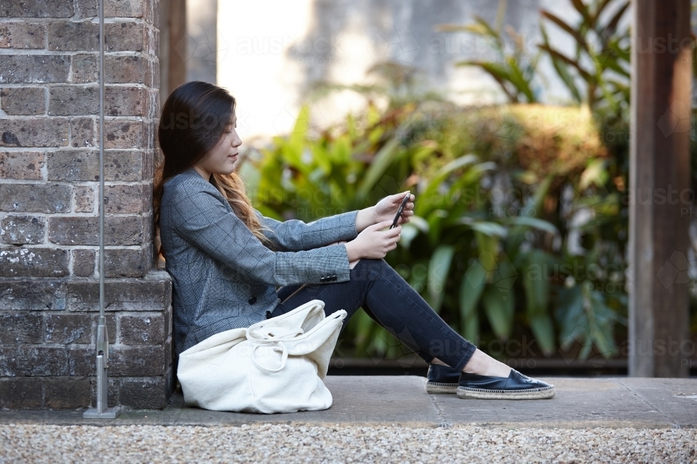 Young Asian woman enjoying time outdoors at enclave - Australian Stock Image