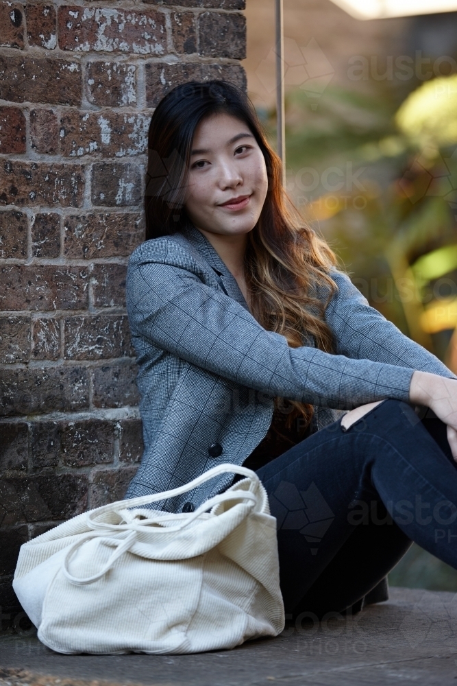 Young Asian woman enjoying time outdoors at enclave - Australian Stock Image
