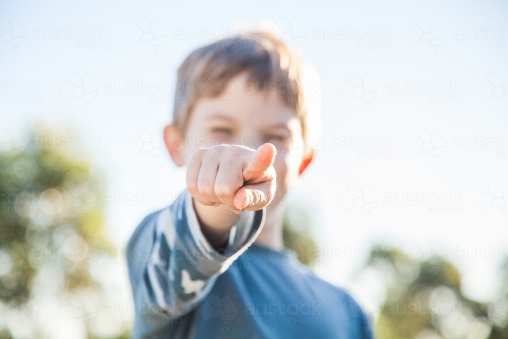 Young Aussie kid pointing a finger at the camera - Australian Stock Image