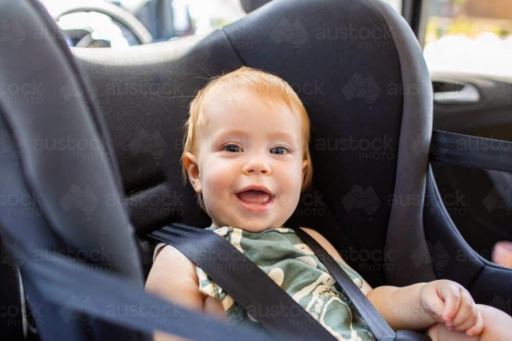 Image of Young australian baby in rear facing car sear Austockphoto