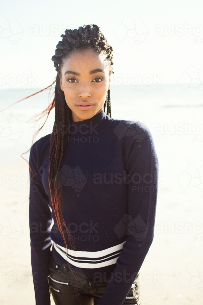 Young black woman posing on the beach - Australian Stock Image