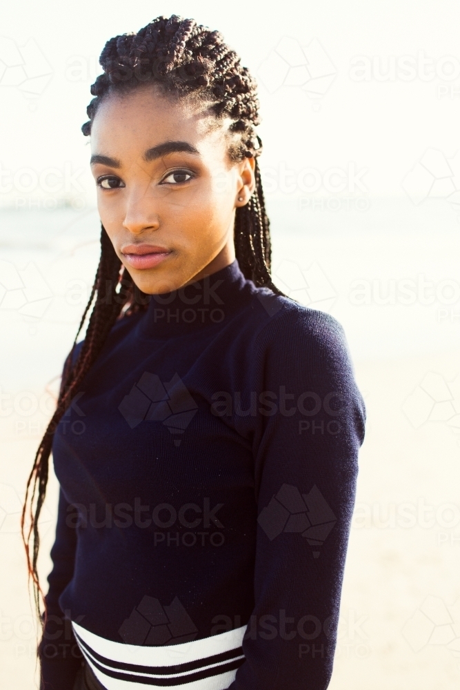 Young black woman posing on the beach - Australian Stock Image