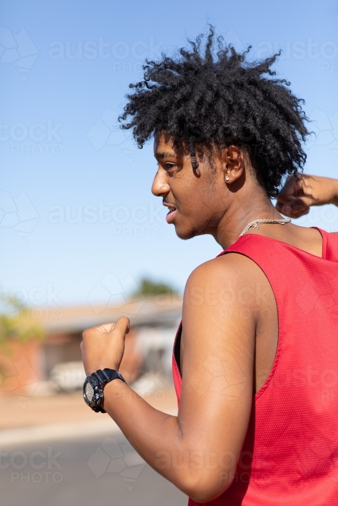 young bloke acting tough with fists clenched - Australian Stock Image