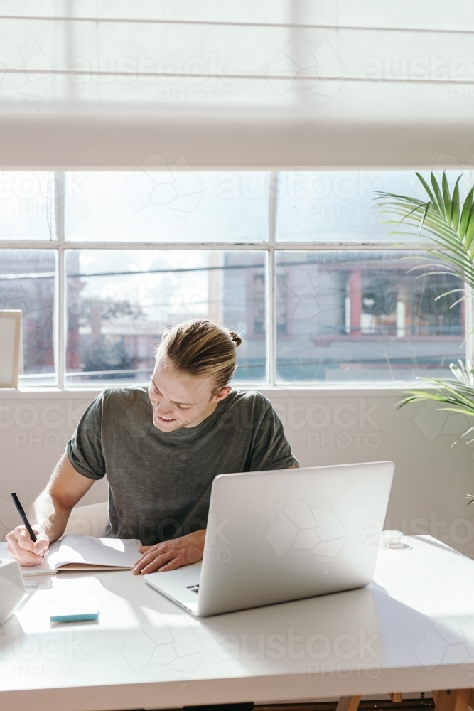 Young blond creative guy in a studio vertical with clear space - Australian Stock Image