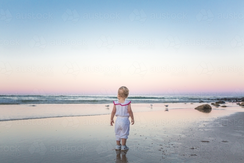 Young blond girl playing at the beach - Australian Stock Image