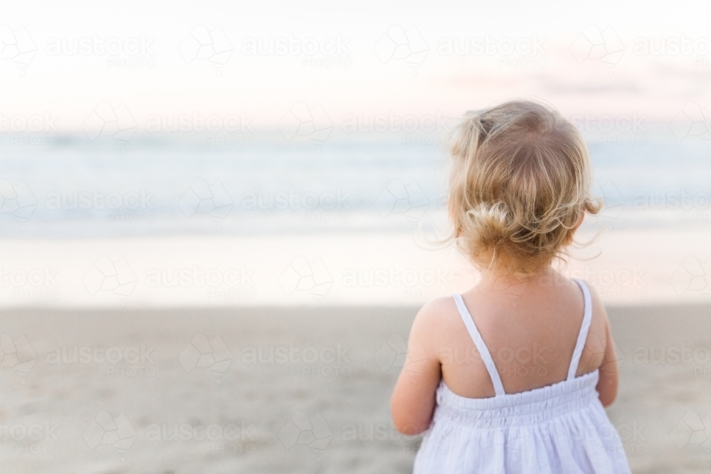 Young blond girl playing at the beach - Australian Stock Image