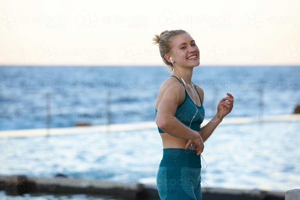 Young blonde-haired woman taking a break from training - Australian Stock Image