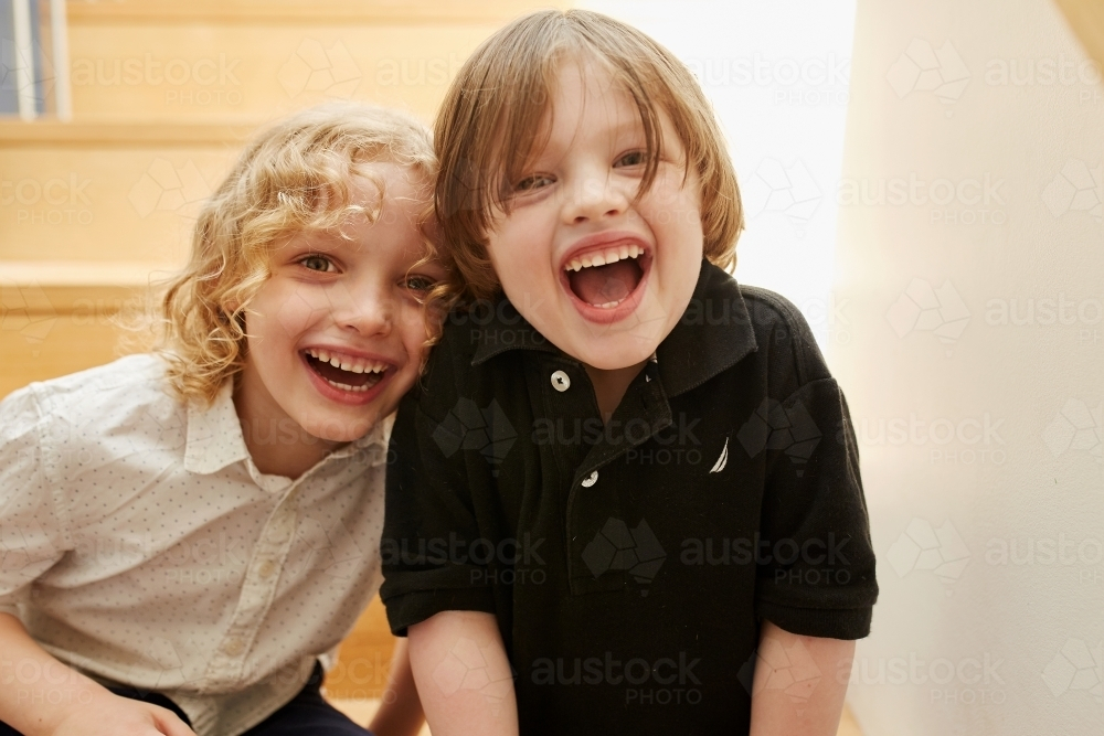 Young boy and girl smiling together indoors - Australian Stock Image