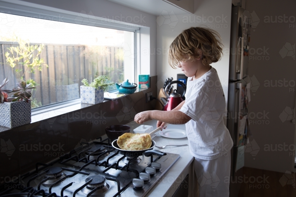 Young boy cooking - Australian Stock Image