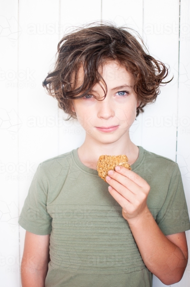 Young boy holding biscuit - Australian Stock Image