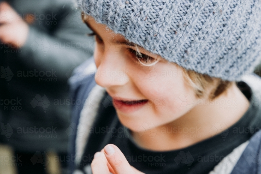 Young boy in beanie on cold winter day close up - Australian Stock Image