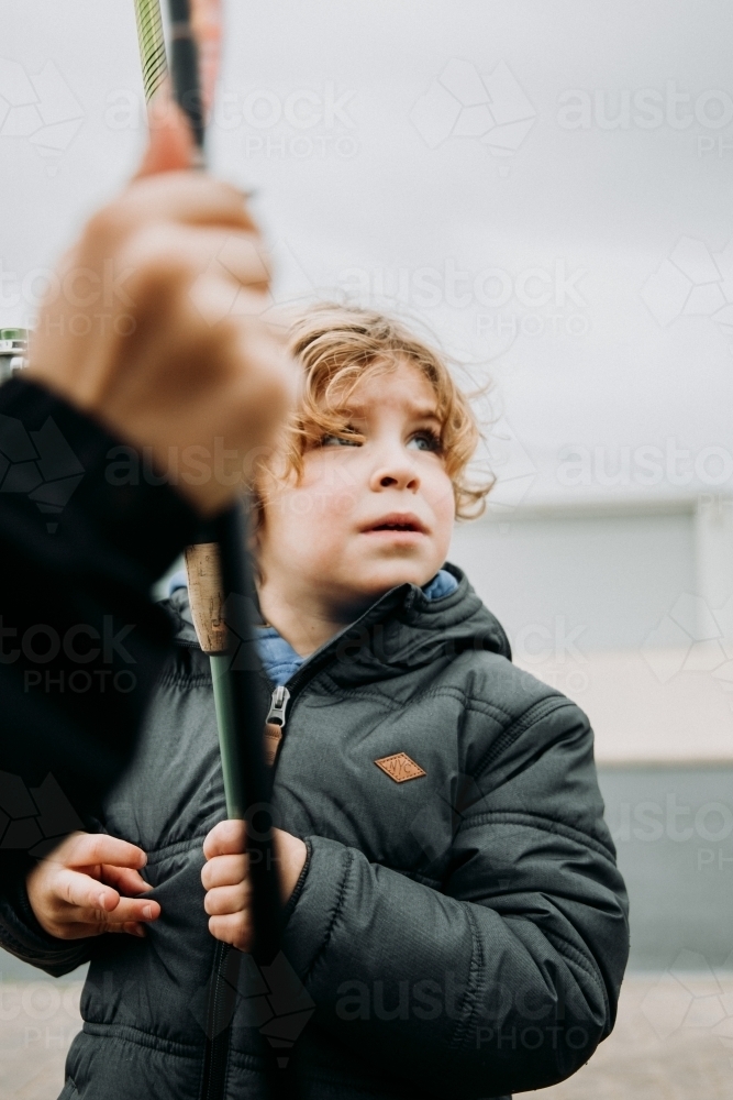 Young boy in warm jacket on overcast winter day - Australian Stock Image