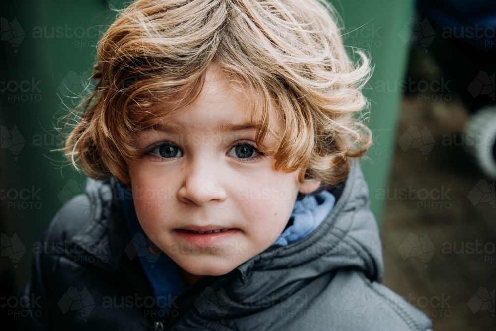 Young boy in warm jacket on overcast winter day - Australian Stock Image