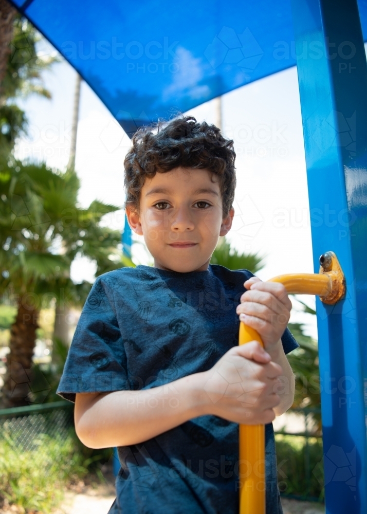 Image of Young boy playing at outdoor playground - Austockphoto