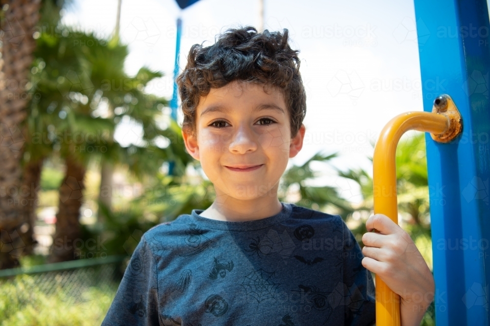Image of Young boy playing at outdoor playground - Austockphoto