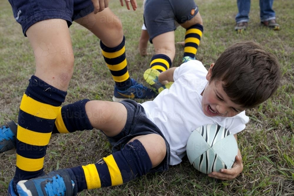 Young boy playing rugby - Australian Stock Image