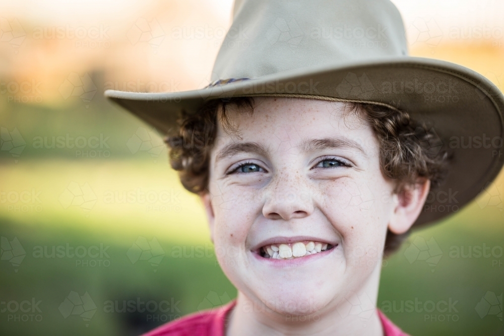 Young boy wearing akubra hat with big smile - Australian Stock Image