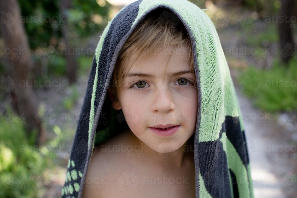 Young boy with beach towel over his head - Australian Stock Image