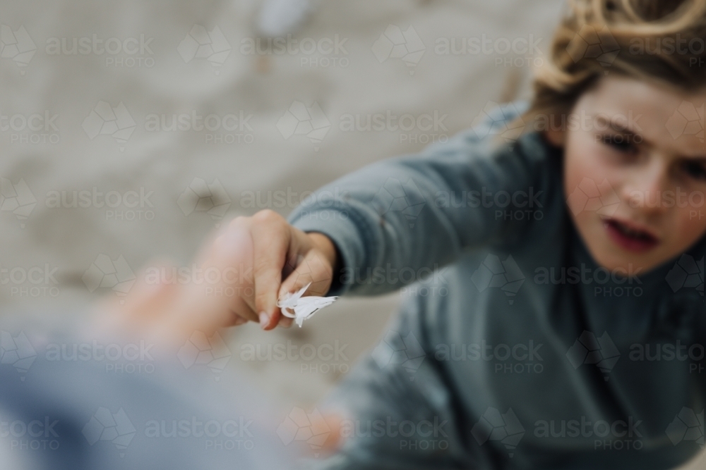 Young boy with feather - Australian Stock Image