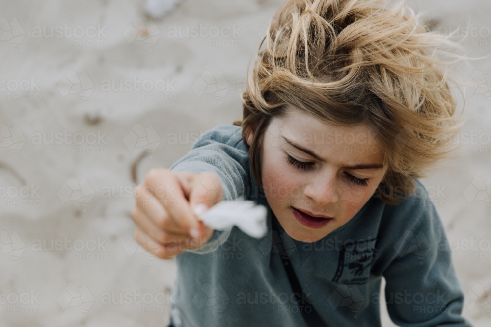 Young boy with feather - Australian Stock Image