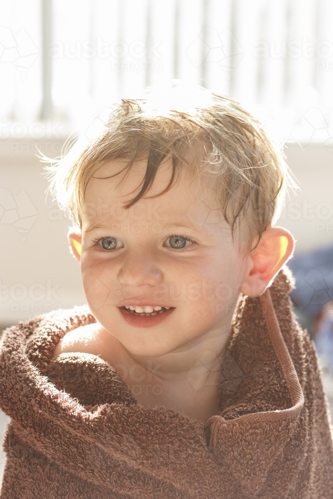 Young boy wrapped in a brown towel - Australian Stock Image