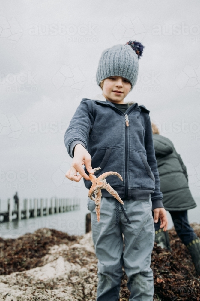 Young boys discover Starfish - Australian Stock Image