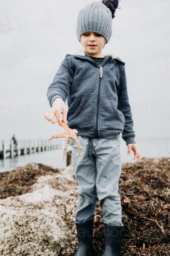 Young boys discover Starfish - Australian Stock Image