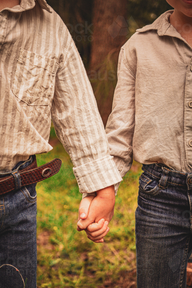 young boys holding hands - Australian Stock Image