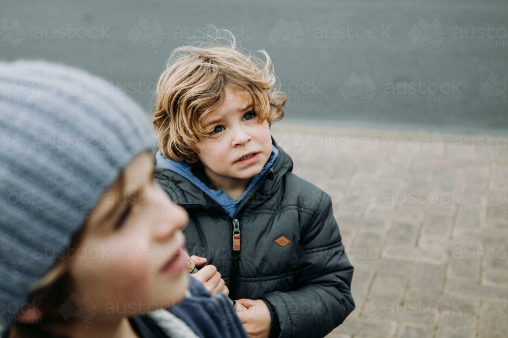Young boys in warm jackets on overcast winter day - Australian Stock Image