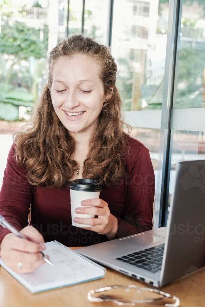 Young business woman having casual meeting at coffee shop - Australian Stock Image