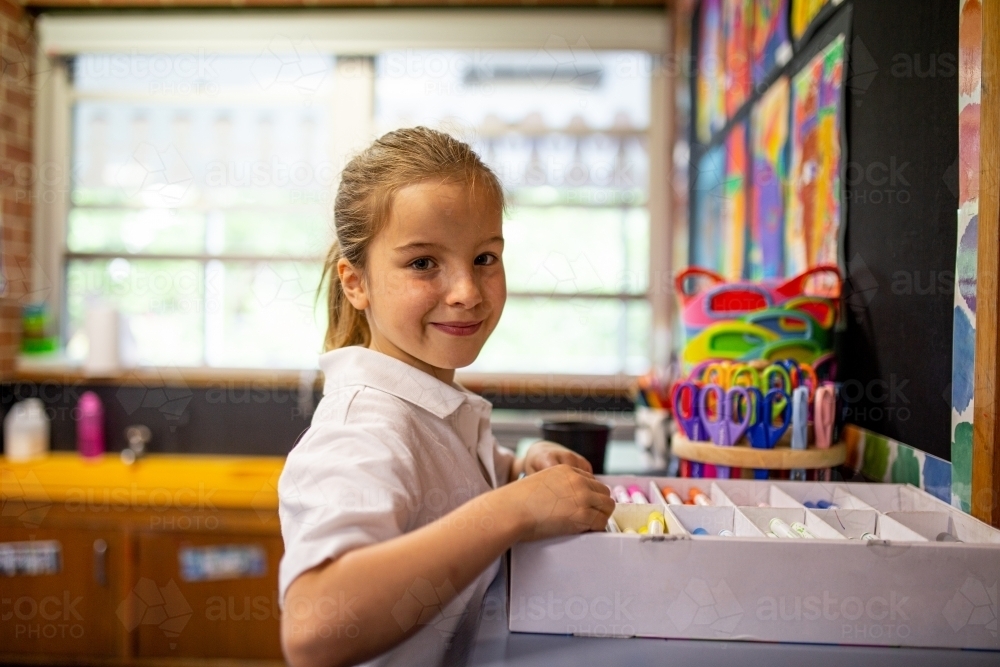 Image of Young Caucasian schoolgirl in classroom smiling at camera ...
