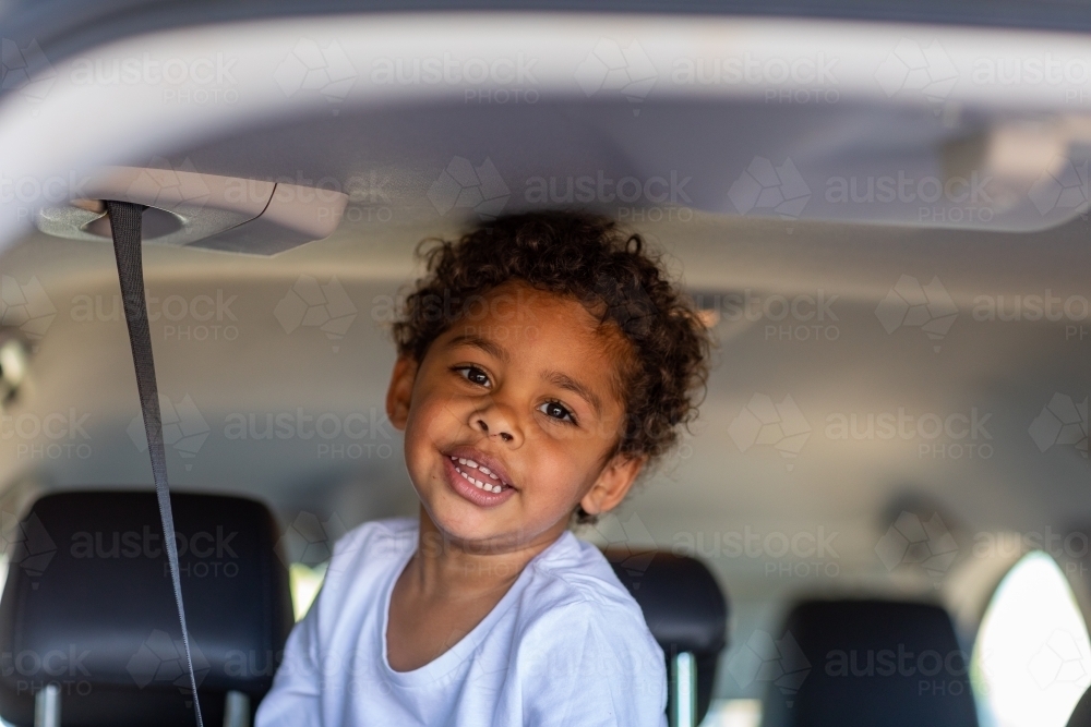 young child in vehicle looking at camera - Australian Stock Image