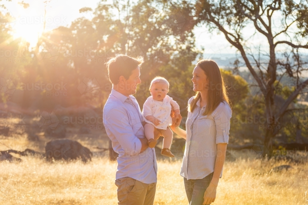Young country couple with their baby outdoors - Australian Stock Image